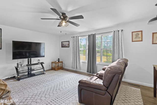 living room featuring hardwood / wood-style floors and ceiling fan