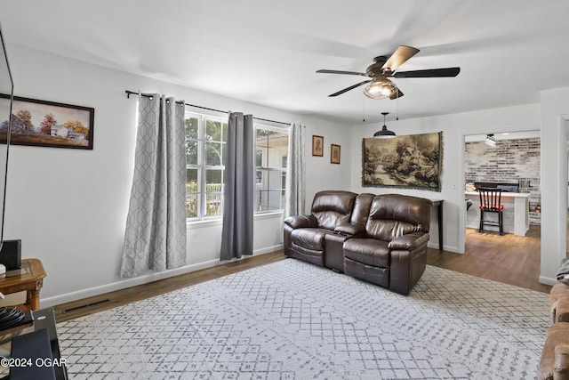 living room with hardwood / wood-style flooring and ceiling fan