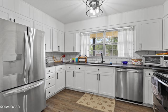 kitchen featuring white cabinetry, stainless steel appliances, and dark hardwood / wood-style floors