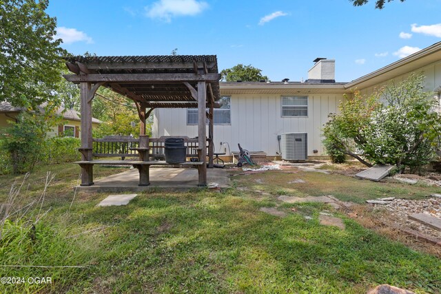 back of house featuring a pergola, a patio, a lawn, and central air condition unit