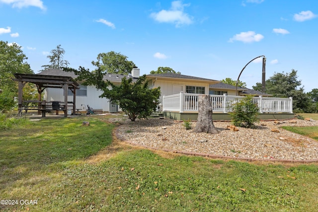 back of house with a gazebo, a wooden deck, and a yard