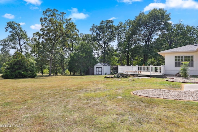 view of yard featuring a storage shed and a wooden deck