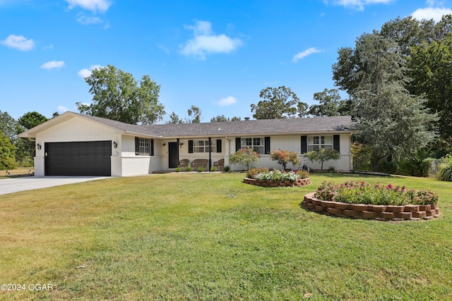 single story home featuring a garage and a front yard