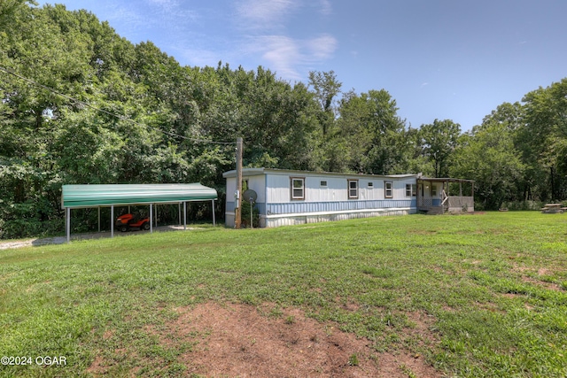 exterior space with a front lawn and a carport