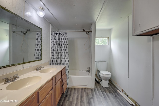 full bathroom with vanity, wood-type flooring, shower / bath combo, and toilet