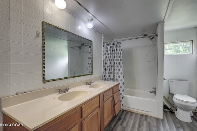 full bathroom with hardwood / wood-style floors, shower / bathtub combination with curtain, toilet, and tile walls