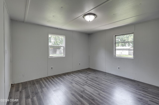 spare room with hardwood / wood-style floors and a healthy amount of sunlight