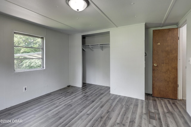 unfurnished bedroom featuring a closet and light hardwood / wood-style flooring