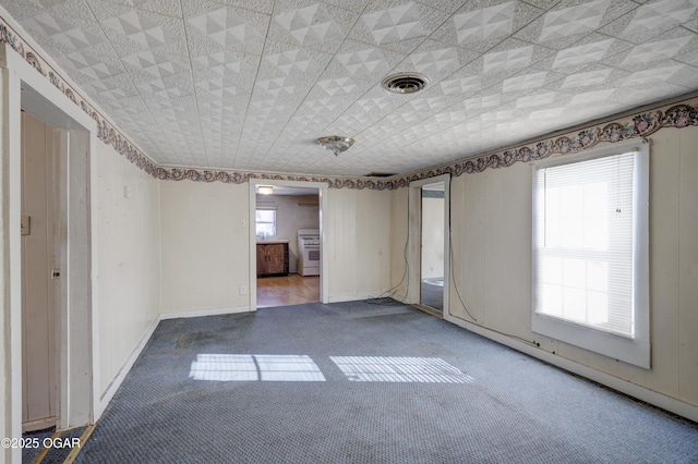 carpeted empty room featuring plenty of natural light