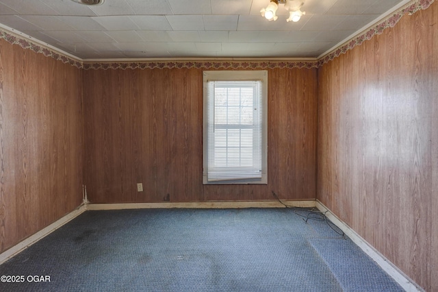 empty room with wood walls and carpet floors