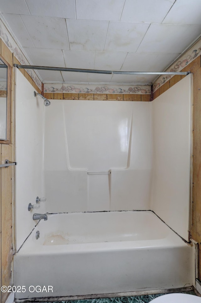 bathroom with toilet and shower / washtub combination