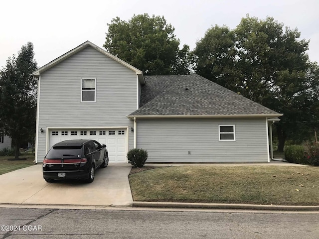 front of property featuring a garage and a front lawn