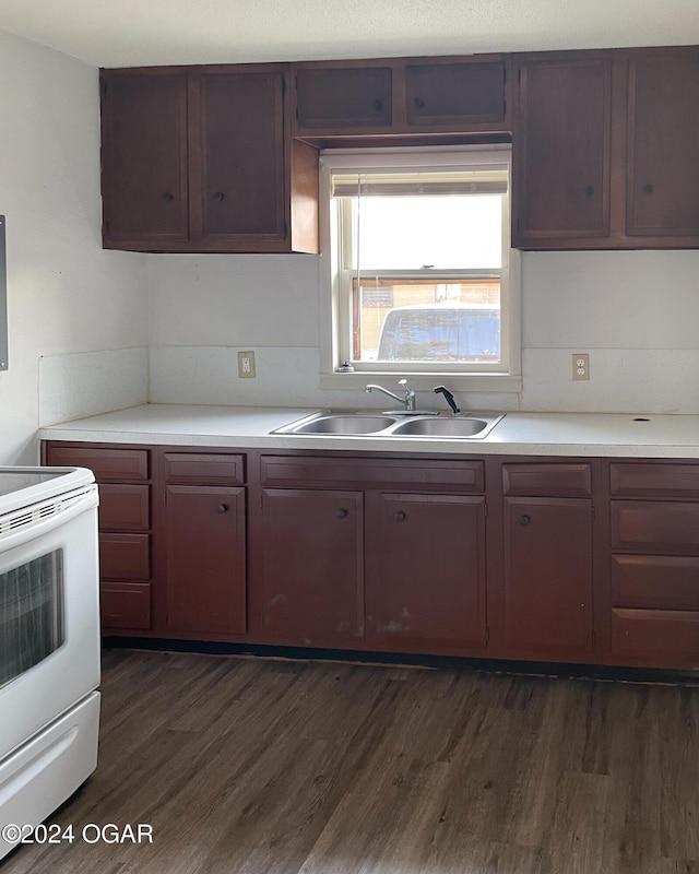 kitchen featuring electric stove, sink, and dark hardwood / wood-style flooring