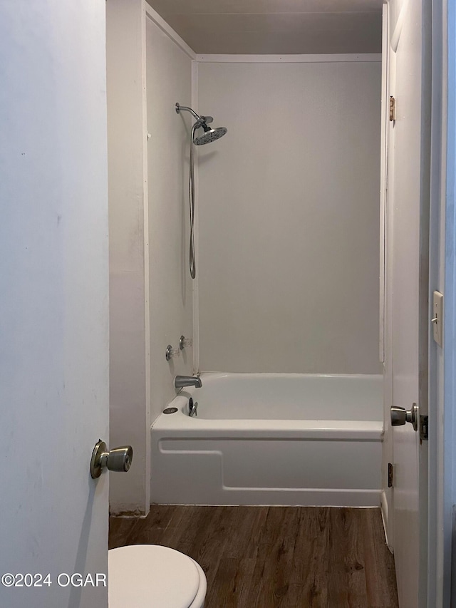 bathroom with wood-type flooring, toilet, and shower / washtub combination