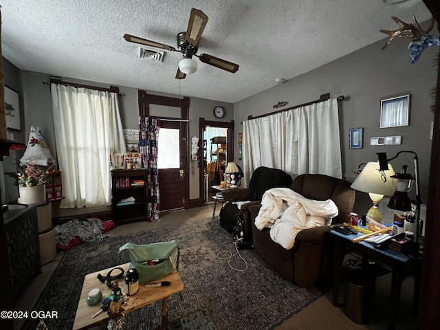 living room featuring a textured ceiling and ceiling fan