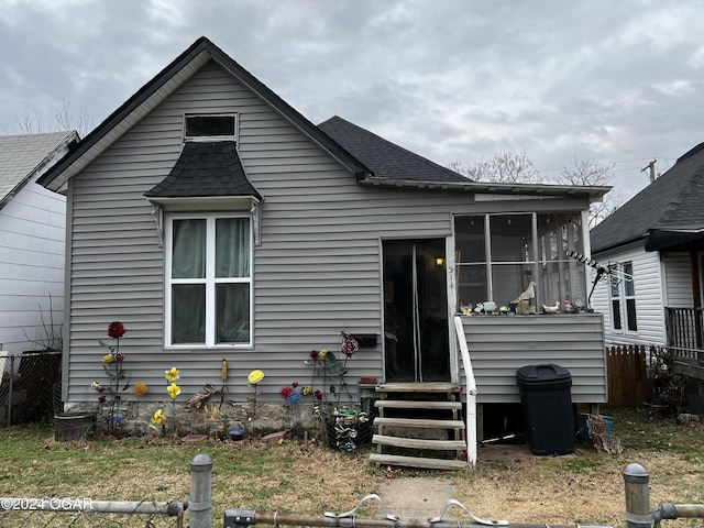 rear view of house featuring a sunroom