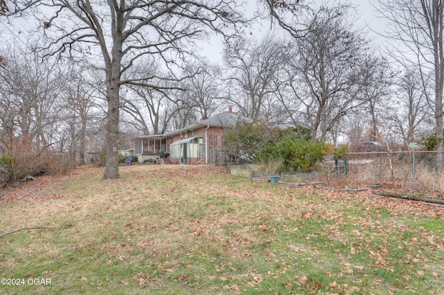 view of yard featuring a sunroom