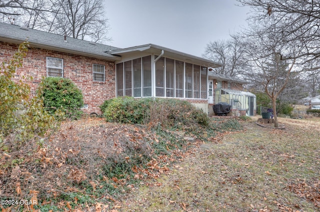 view of home's exterior featuring a sunroom