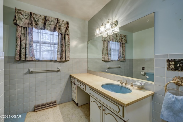 bathroom featuring vanity and tile walls