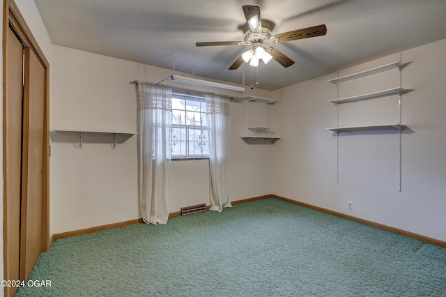 interior space with carpet flooring, ceiling fan, and a closet