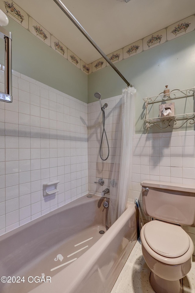 bathroom featuring shower / bath combo and toilet