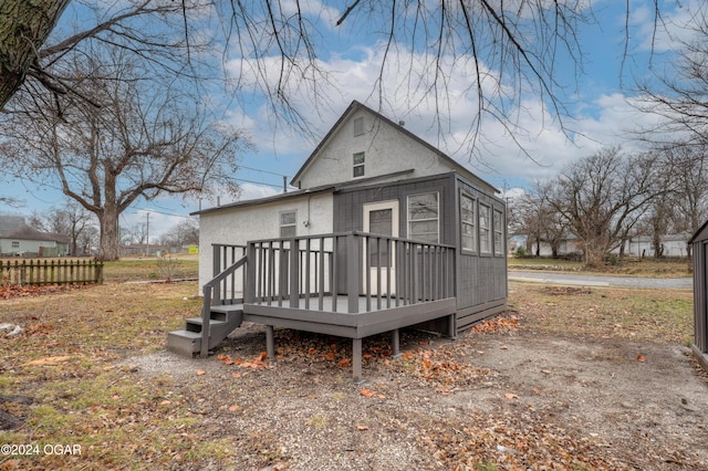 back of house featuring a deck