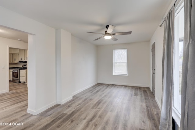 unfurnished room with ceiling fan and light hardwood / wood-style floors