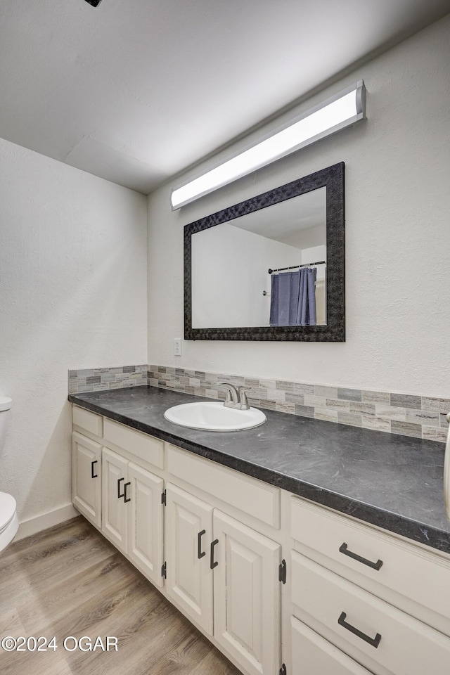 bathroom featuring vanity, toilet, and wood-type flooring