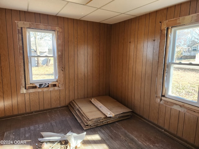 118 S Oak St, Mulberry, KS 66756 - spare room featuring hardwood / wood-style flooring, wood walls, and a wealth of natural light