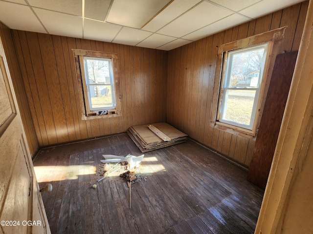 118 S Oak St, Mulberry, KS 66756 - empty room with dark hardwood / wood-style floors, a wealth of natural light, and wood walls