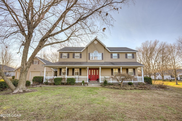 farmhouse featuring a front yard and a garage