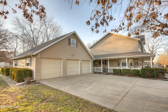 view of front of home featuring a porch and a garage