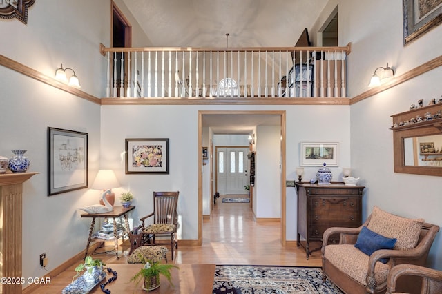 living room with light hardwood / wood-style flooring and a high ceiling