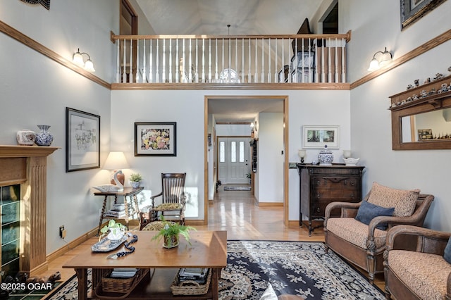 living room featuring light hardwood / wood-style floors and a high ceiling