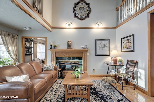 living room featuring hardwood / wood-style floors and a tiled fireplace