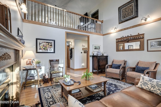 living room with a high ceiling and light hardwood / wood-style flooring