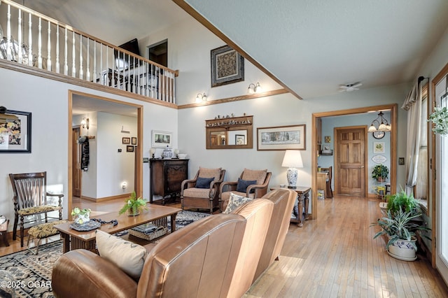 living room with an inviting chandelier and light hardwood / wood-style flooring