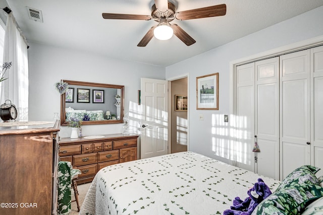 bedroom with ceiling fan and a closet