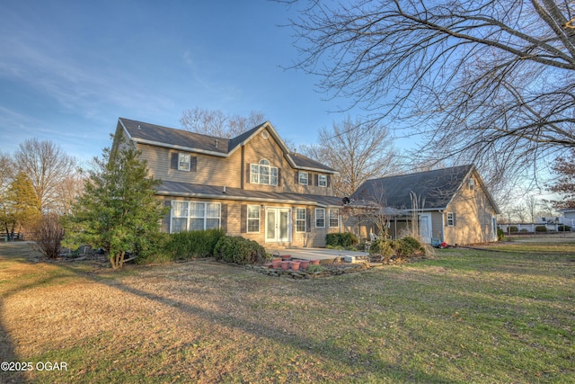 view of front of home featuring a front lawn and a patio area