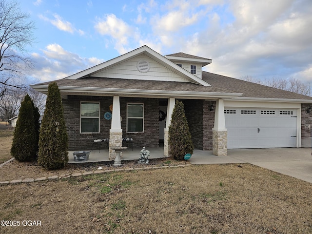 view of front of house featuring covered porch, a front yard, and a garage