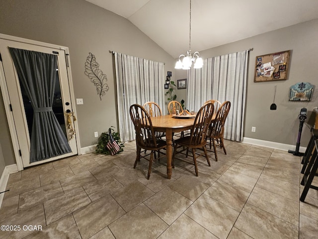 dining space with vaulted ceiling and a notable chandelier