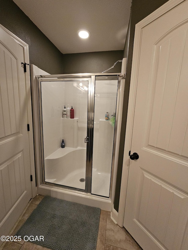 bathroom featuring tile patterned flooring and walk in shower