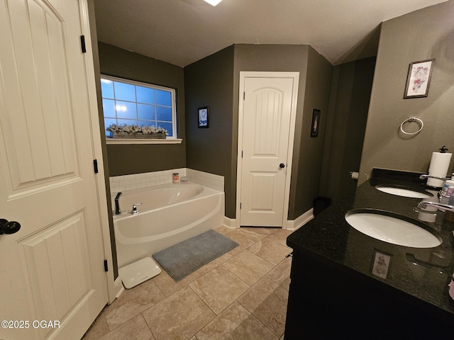 bathroom featuring tile patterned floors, a bathtub, and vanity