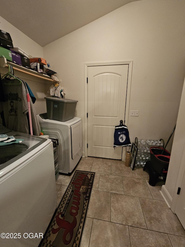 clothes washing area with light tile patterned flooring and washing machine and dryer