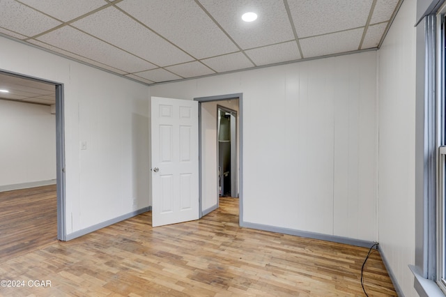 unfurnished bedroom featuring light hardwood / wood-style floors, a walk in closet, and a closet