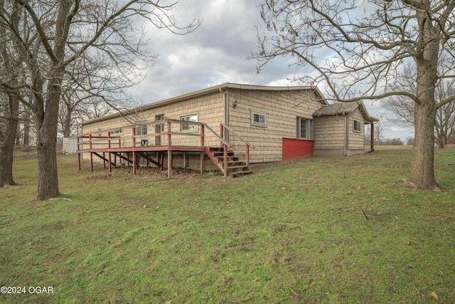 rear view of house with a yard and a wooden deck