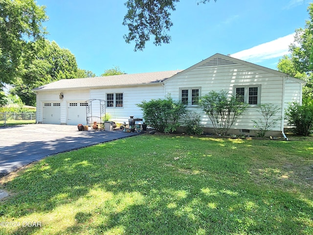 single story home featuring a front yard and a garage