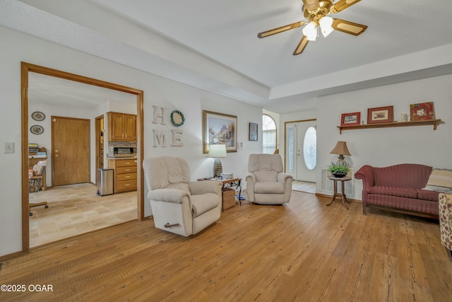 living room featuring ceiling fan and light hardwood / wood-style floors