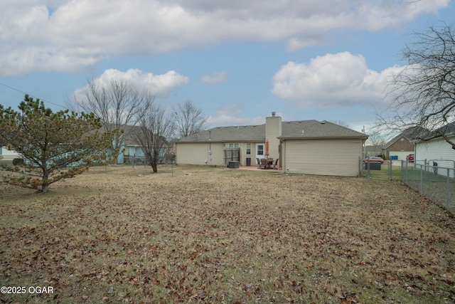 rear view of house featuring a lawn and a patio area