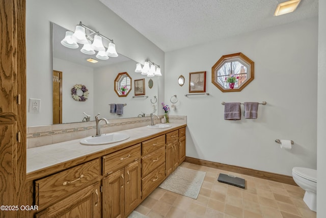 bathroom with tile patterned floors, backsplash, a textured ceiling, toilet, and vanity